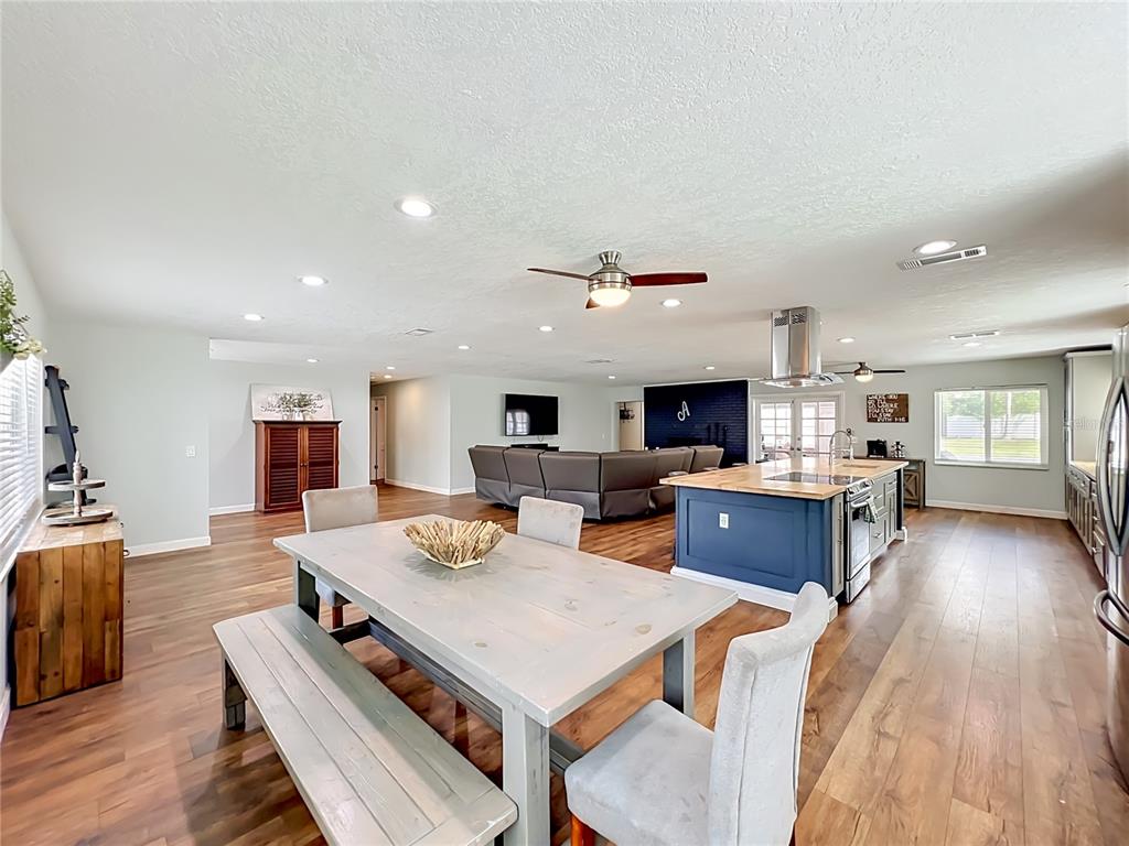 153 Variety Tree Circle Altamonte Springs, FL 32714 - Photo 7 of 44 a living room with furniture a wooden floor and a fireplace