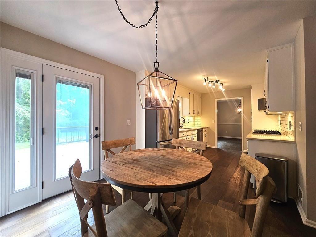 290 Oakmere Road Alpharetta, GA 30009 - Photo 4 of 26 a view of a dining room with furniture and wooden floor