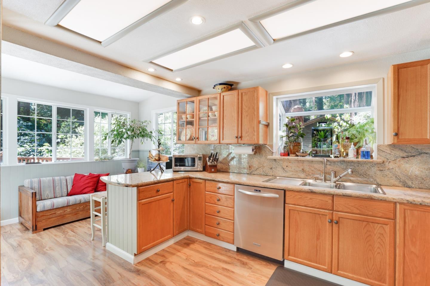 64 Pope Road La Honda, CA 94020 - Photo 11 of 32 a kitchen with granite countertop kitchen island sink stove and white cabinets