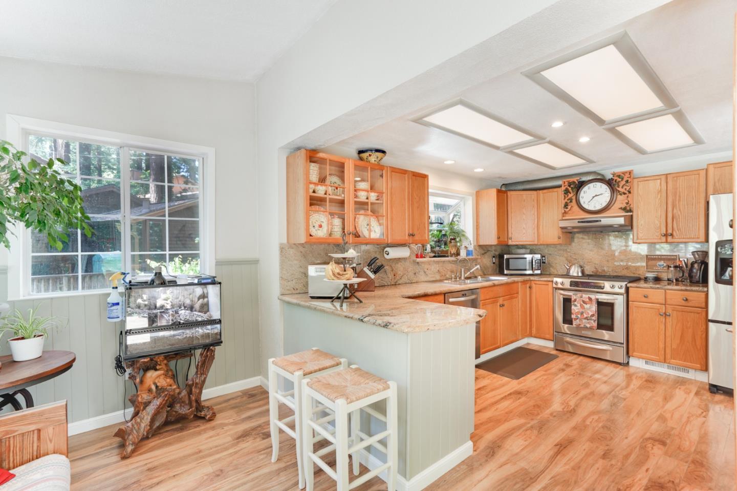 64 Pope Road La Honda, CA 94020 - Photo 13 of 32 a kitchen with stainless steel appliances kitchen island granite countertop a stove and a refrigerator