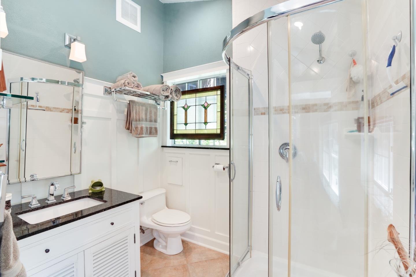 64 Pope Road La Honda, CA 94020 - Photo 17 of 32 a bathroom with a granite countertop sink mirror and toilet