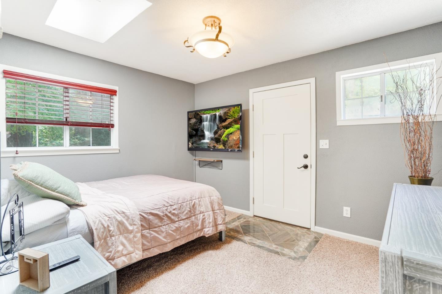 64 Pope Road La Honda, CA 94020 - Photo 21 of 32 a bedroom with a bed and a chandelier