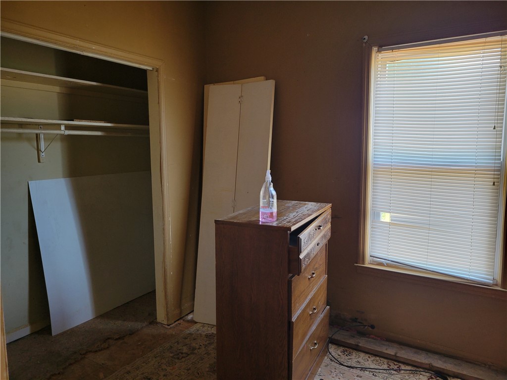 1208 East Main Street Seneca, SC 29678 - Photo 13 of 19 This cozy bedroom offers a walk-in closet and a bright window.