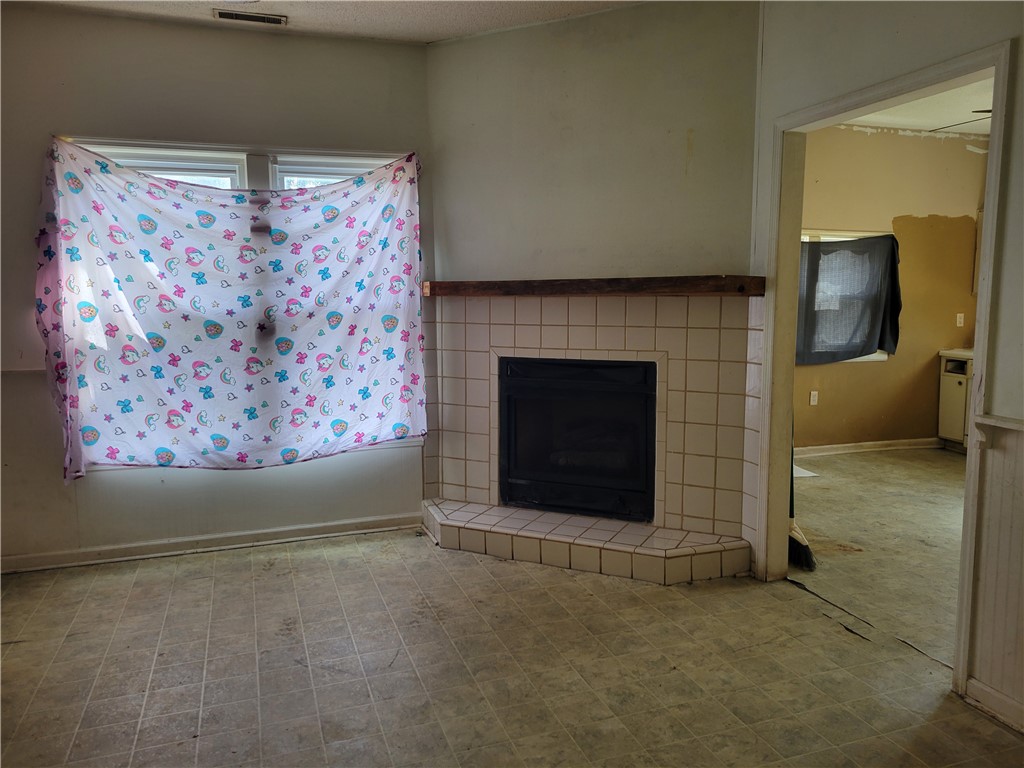1208 East Main Street Seneca, SC 29678 - Photo 15 of 19 This versatile living area offers potential with a charming fireplace and ample natural light.