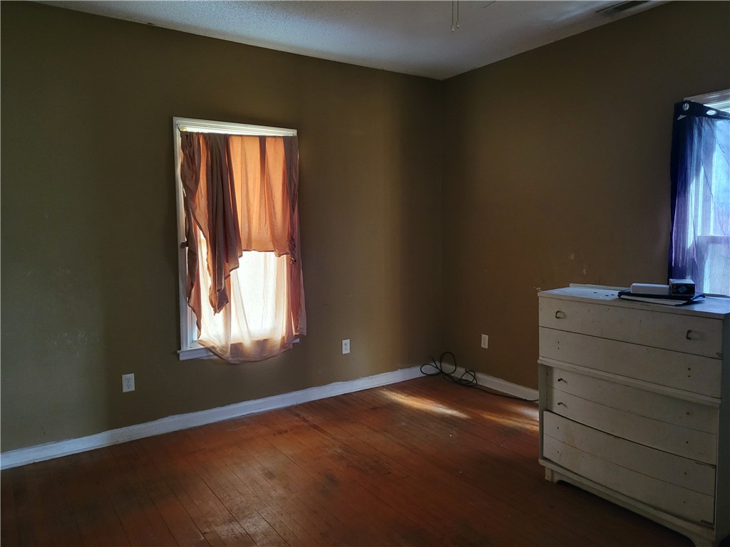 1208 East Main Street Seneca, SC 29678 - Photo 16 of 19 This inviting bedroom features rich hardwood flooring and abundant natural light.