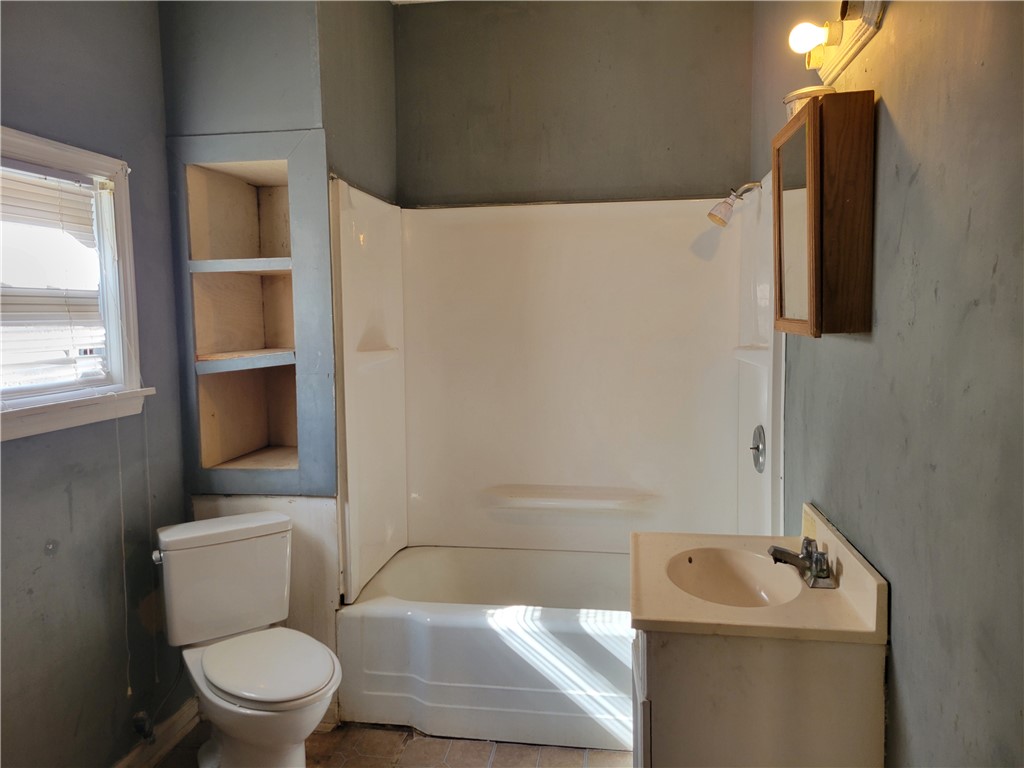 1208 East Main Street Seneca, SC 29678 - Photo 19 of 19 This bathroom features practical built-in shelving, a full bath, and a simple vanity.