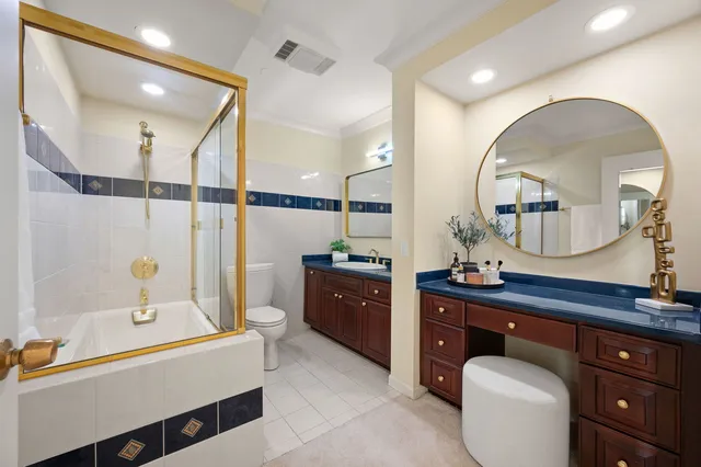 a spacious bathroom with a bathtub sink and mirror