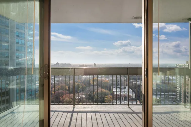 a view of a balcony with floor to ceiling window wooden floor