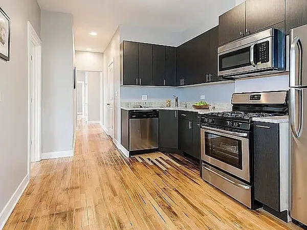a kitchen with stainless steel appliances a stove a microwave and cabinets