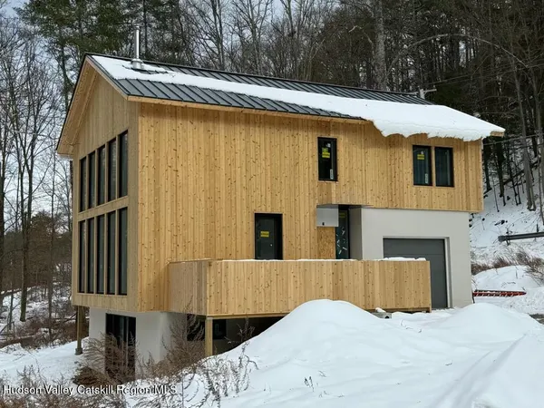 a view of a house with a yard and furniture