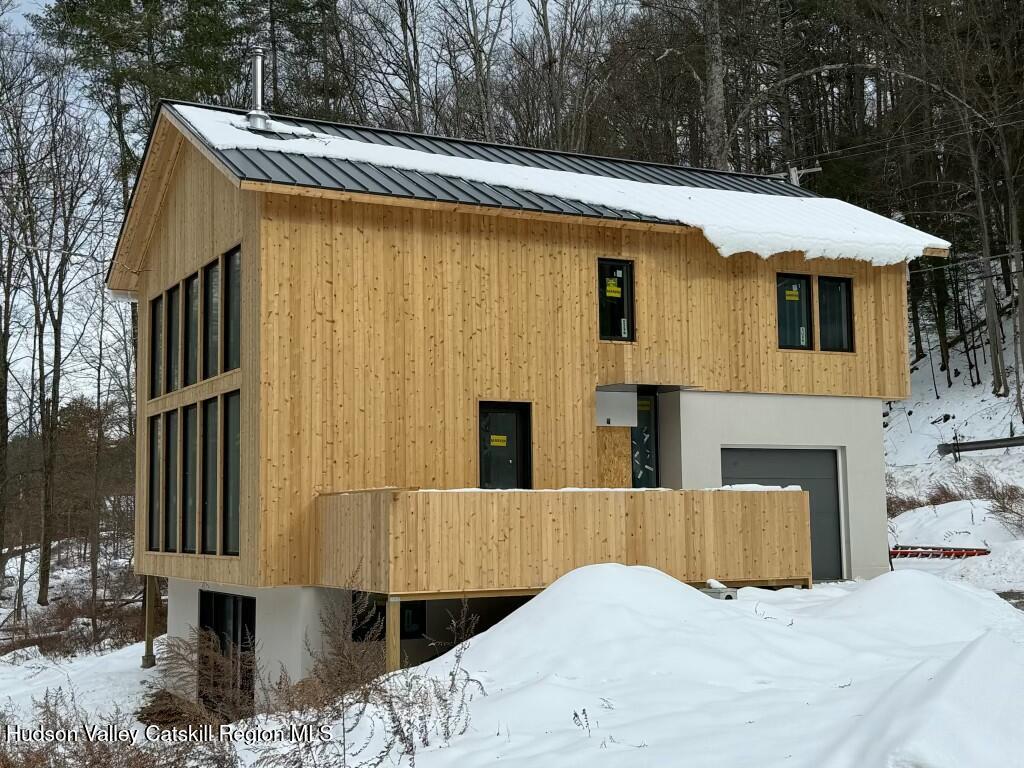 a view of a house with a yard and furniture