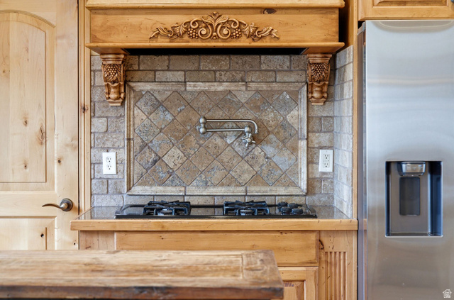3634 North Huntsman Path, Unit C203 Eden, UT 84310 - Photo 19 of 27 Built-in gas cooktop with a decorative tile backsplash and a wall-mounted pot filler
