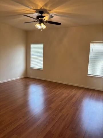 a view of livingroom with hardwood floor and ceiling fan