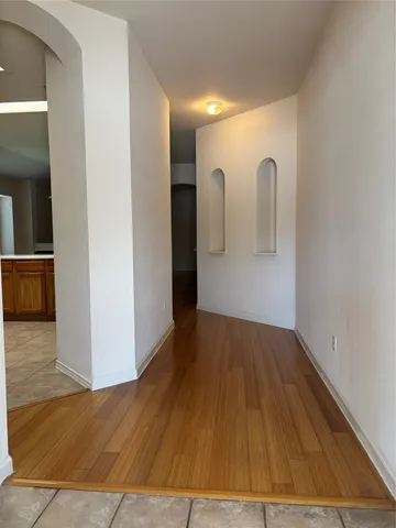 a view of a room with wooden floor