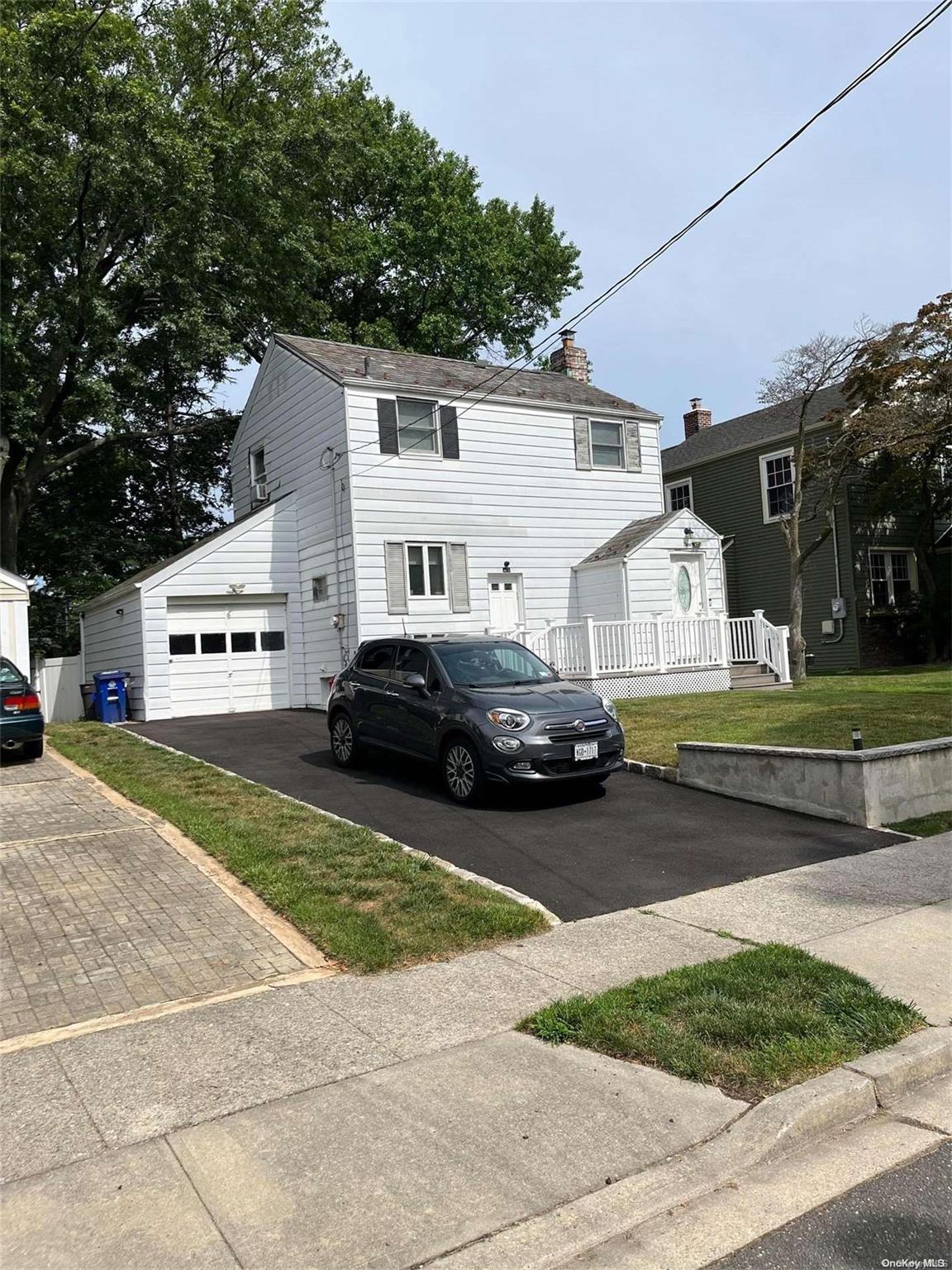 9 Gotham Street Valley Stream, NY 11581 - Photo 1 of 1 a car parked in front of a white house