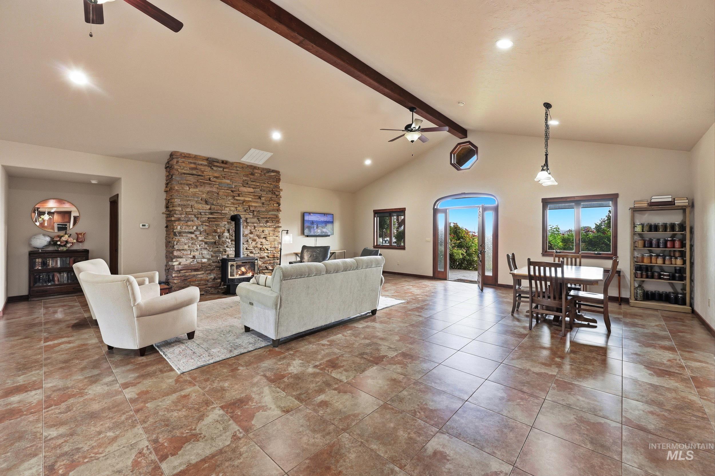 339 Airport Road Weiser, ID 83672 - Photo 8 of 49 Spacious room featuring vaulted ceilings with exposed beams, recessed lighting, and large format tile flooring