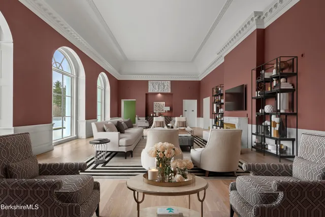 an aerial view of a house with a garden and lake view