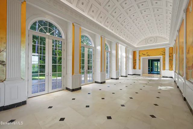 a living room with furniture fireplace and a large window