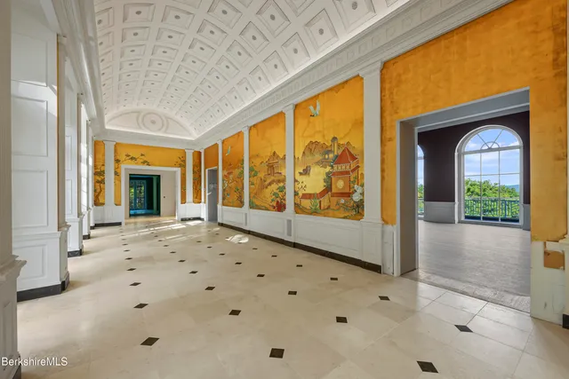 a dining room with furniture and a clock