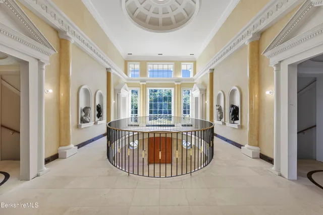 a bedroom with a bed and glass window