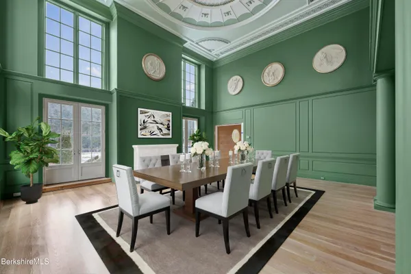 a view of a dining room with furniture and wooden floor