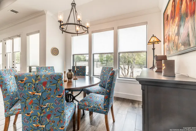 a view of a dining room with furniture and a floor to ceiling window