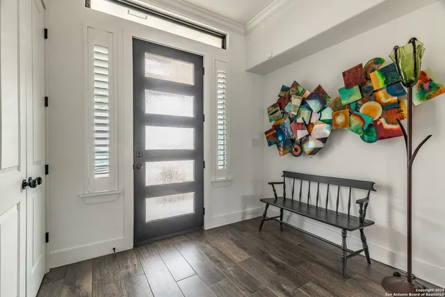 a view of an entryway with wooden floor