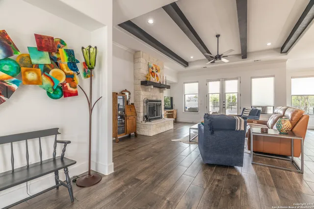 a living room with furniture fireplace and a window