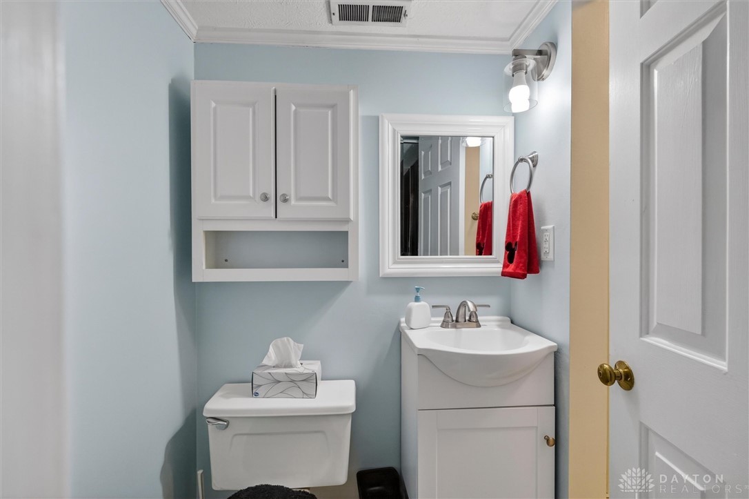 2165 Stewart Road Xenia, OH 45385 - Photo 20 of 59 This bright bathroom features ample storage, a modern vanity, and a convenient toilet.