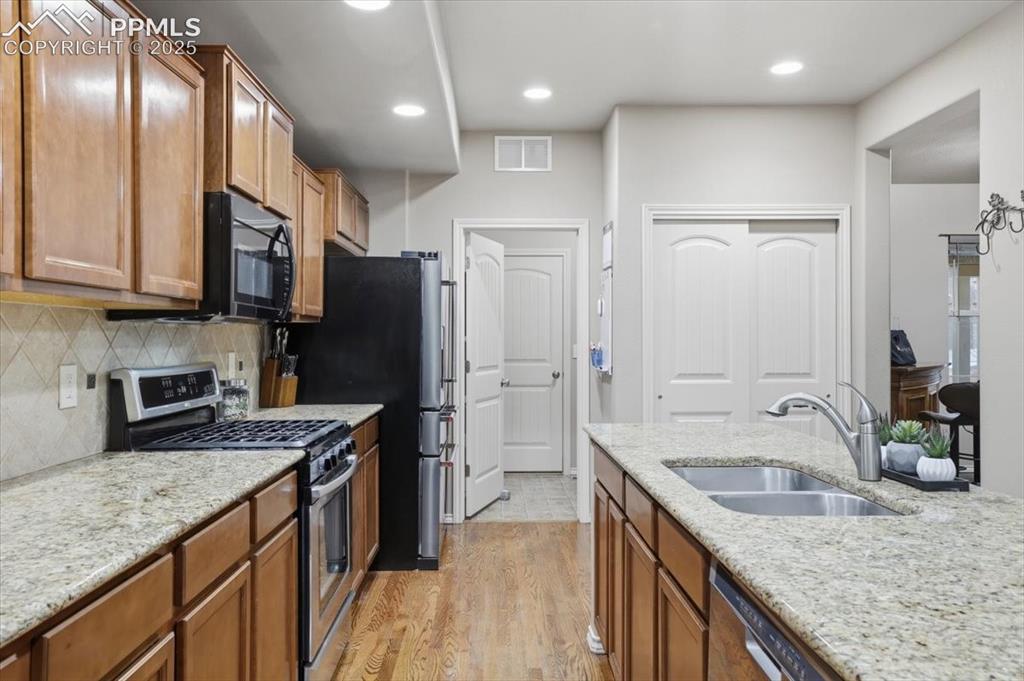 2374 Cinnabar Road Colorado Springs, CO 80921 - Photo 20 of 48 The kitchen has stainless steel appliances including a gas range.