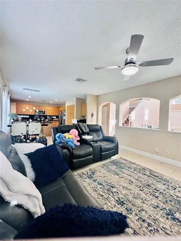 a living room with furniture a rug and a chandelier