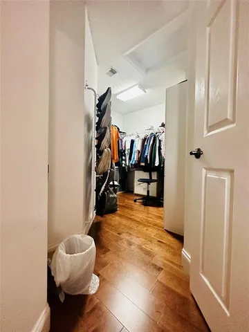 a view of a gallery with wooden floor