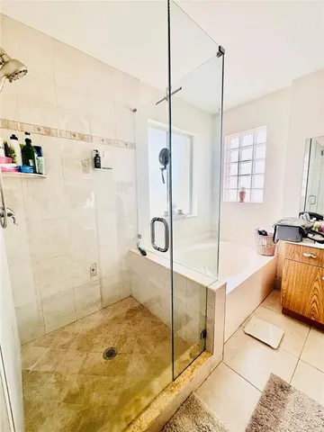 a bathroom with a tub and a shower