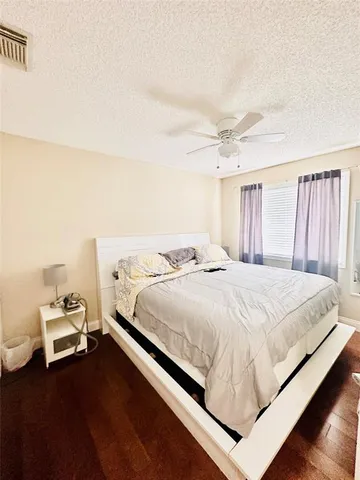 a large bed sitting in a bedroom and chandelier