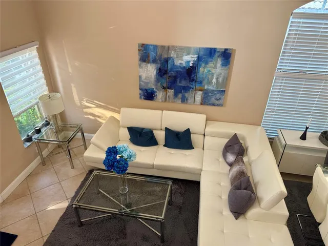 a living room with furniture and a potted plant