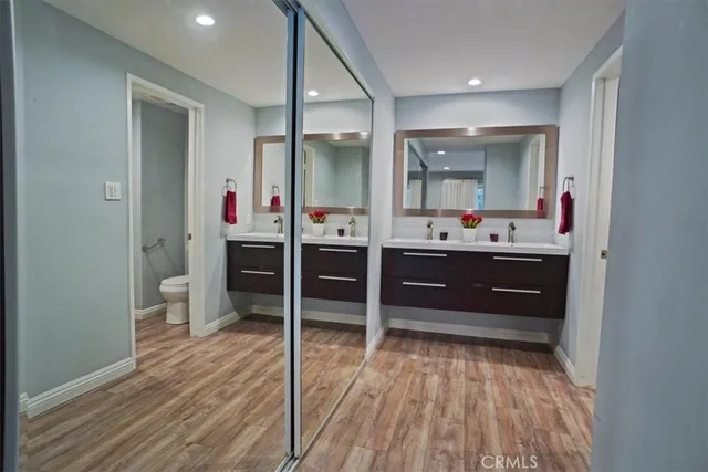 a room with wooden floors and white walls