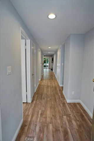 a view of a hallway with wooden floor