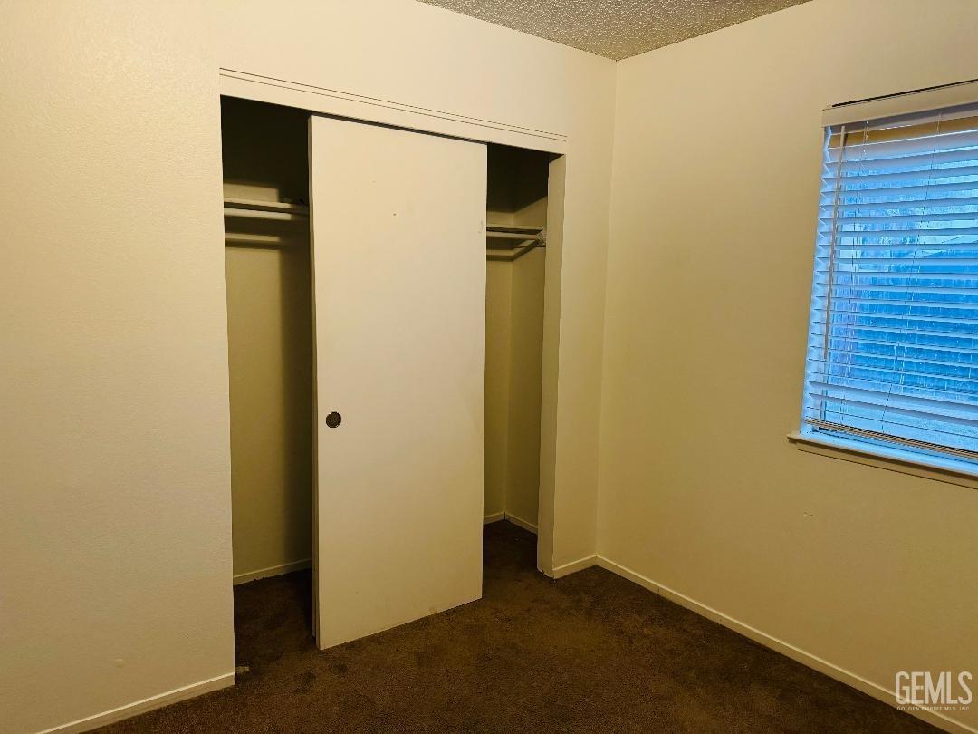 Undisclosed Address Arvin, CA 93203 - Photo 24 of 29 a view of an empty room with wooden floor and a window