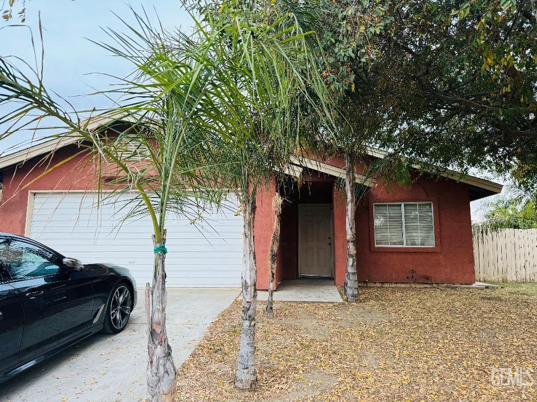 Undisclosed Address Arvin, CA 93203 - Photo 3 of 29 a view of a house with a couches and a large tree