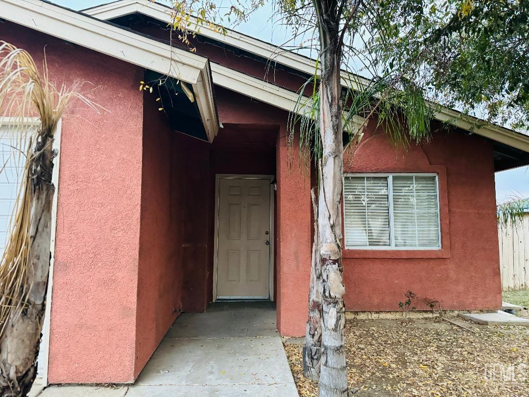 Undisclosed Address Arvin, CA 93203 - Photo 4 of 29 a front view of a house with a yard