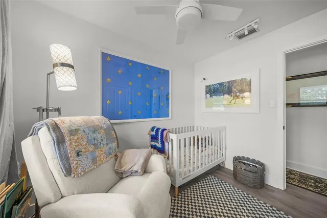 a living room with patio furniture and a floor to ceiling window