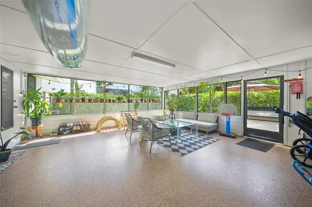a view of a patio with table and chairs potted plants with wooden fence
