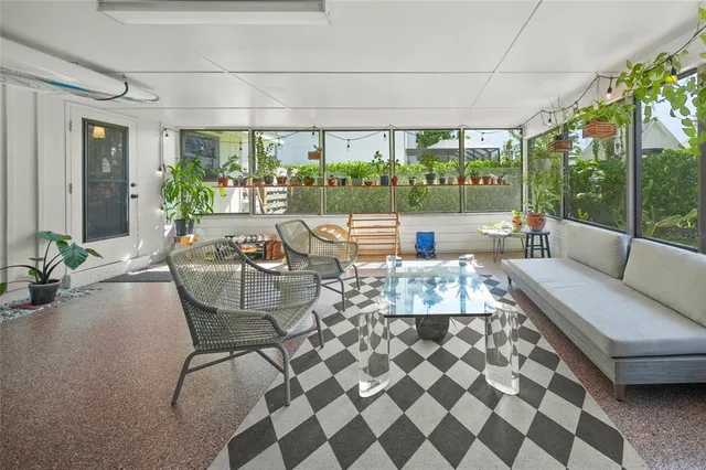 a view of a backyard with potted plants and large tree