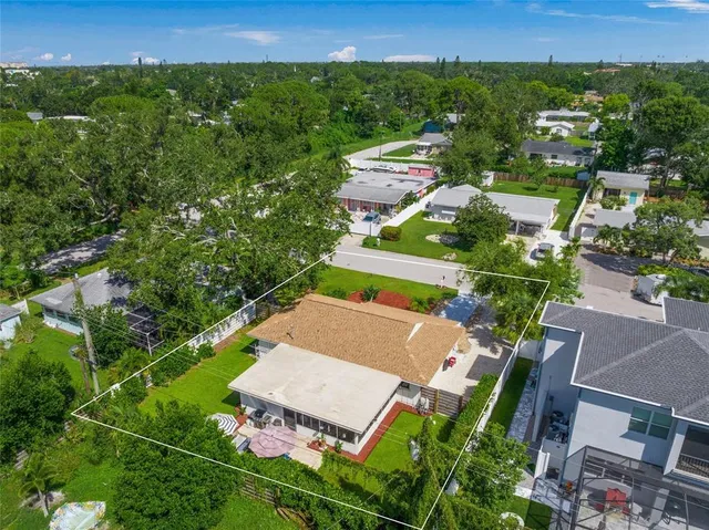 a front view of a building with garden and plants