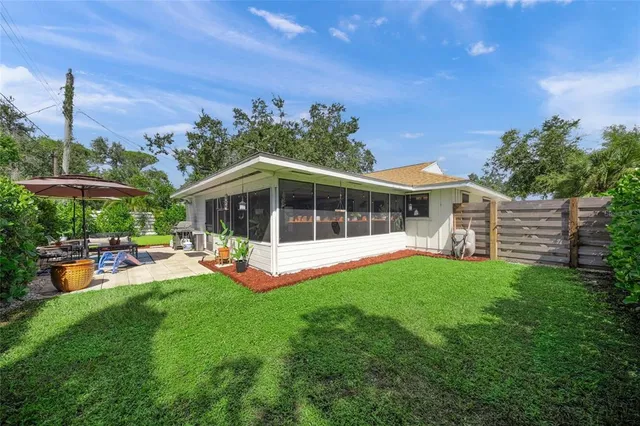 a view of a house with backyard sitting area and garden