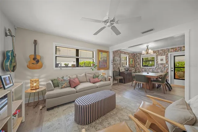 a living room with furniture a table and a large window