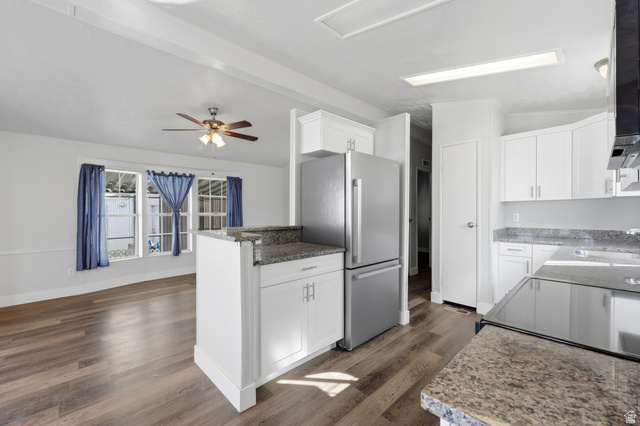 150 West 7500th South, Unit 55 Midvale, UT 84047 - Photo 16 of 28 Open-concept kitchen and living area featuring wood-finish flooring, white cabinetry, and granite-style countertops
