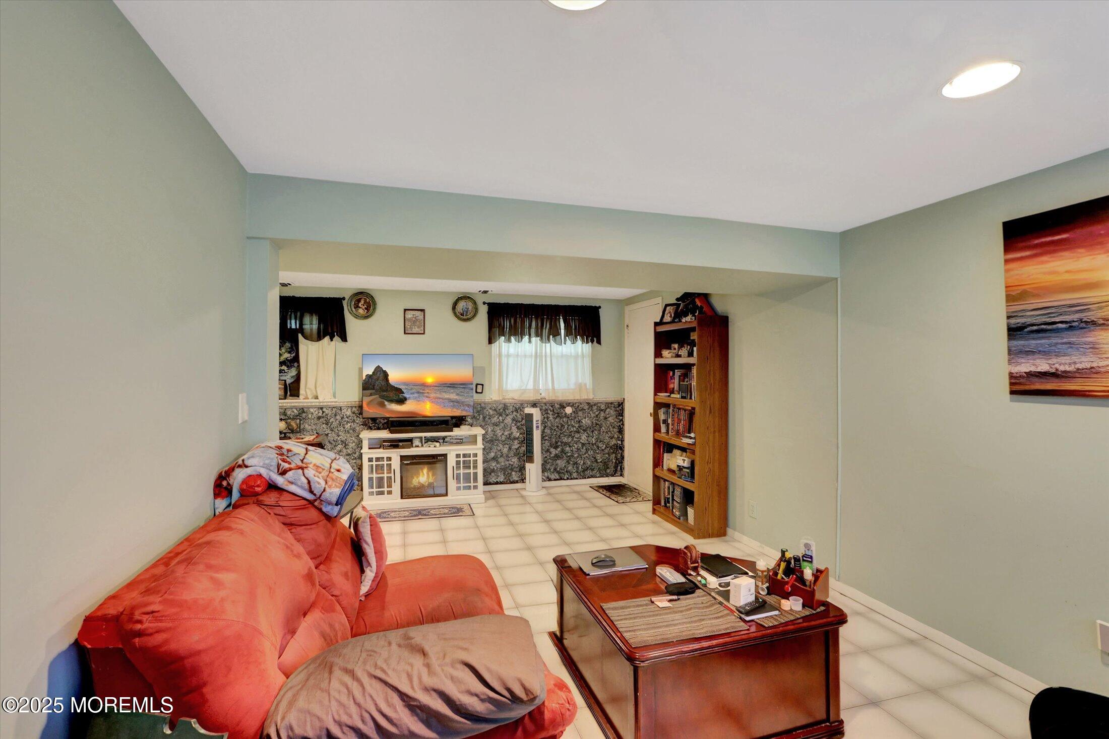 12 Steven Place Jackson, NJ 08527 - Photo 16 of 31 a living room with furniture and a flat screen tv