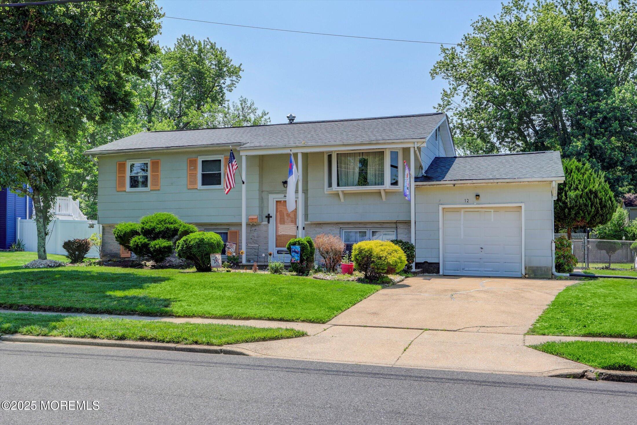 12 Steven Place Jackson, NJ 08527 - Photo 31 of 31 a front view of a house with a yard and garage