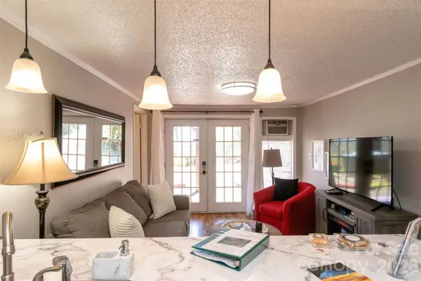 a living room with furniture a lamp and a flat screen tv